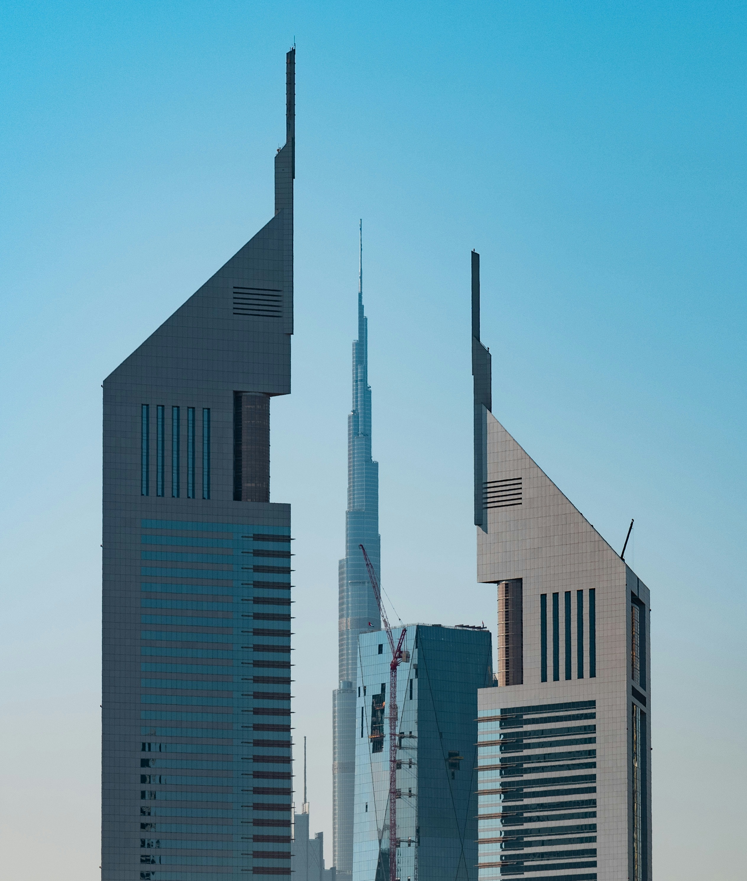 The Emirates Towers in Dubai against a clear blue sky