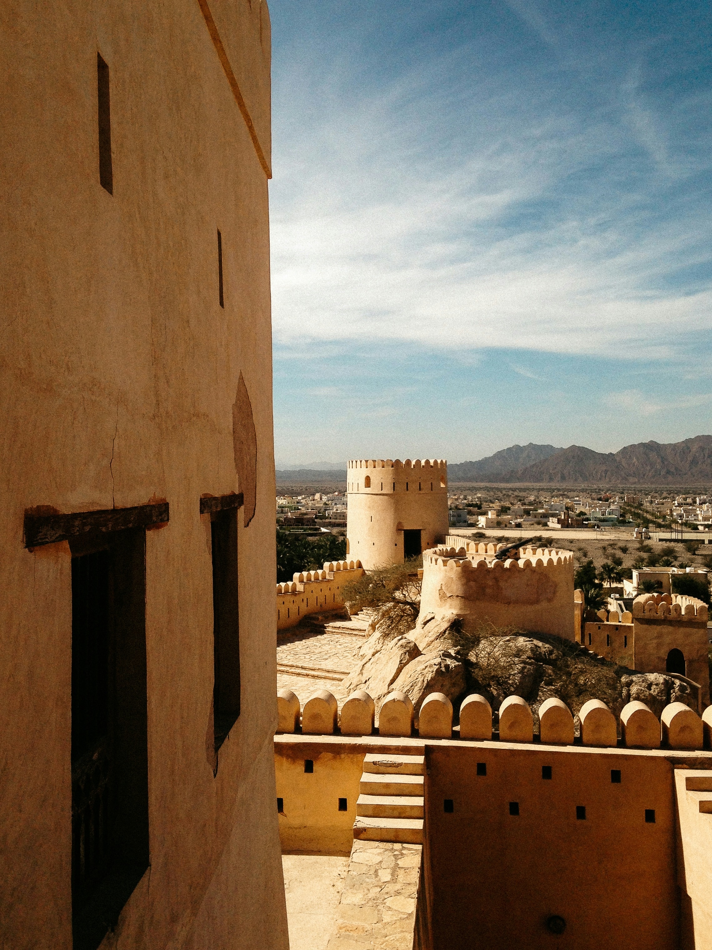 The sandstone walls and tower of Nizwa Fort in Oman